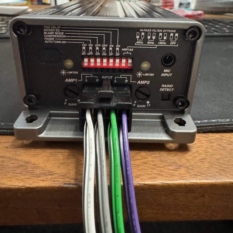 An amplifier on the workbench, DIP switches and wiring exposed, waiting to be figured out