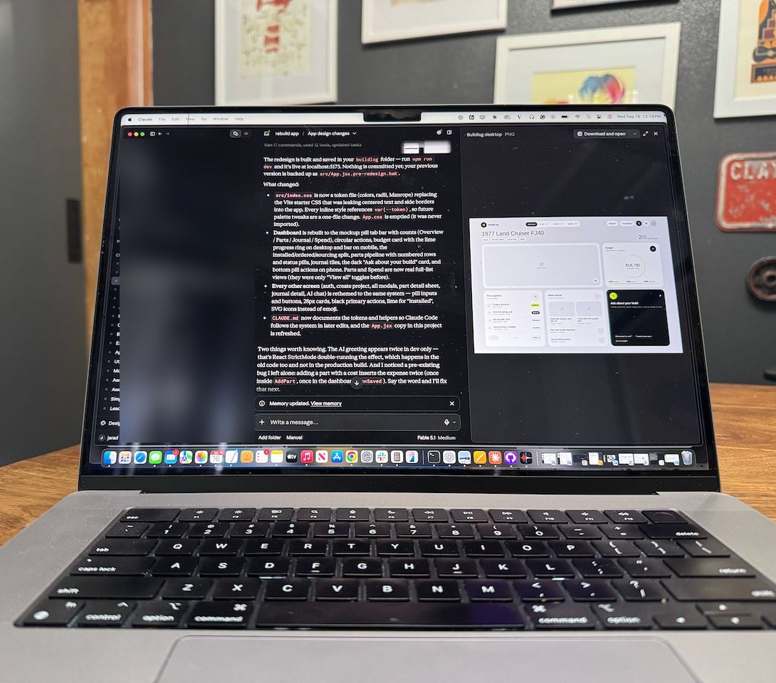 MacBook on the workbench with Claude Code open, walking through a BuildLog redesign step by step